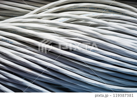 bunch of network cables in wave pattern leading across server ro 119387381