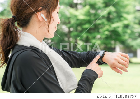 運動中にスマートウォッチを操作する女性（ヘルスケア・音楽・ワークアウト） 119388757