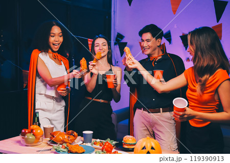 Joyful office Halloween party with coworkers in costumes, celebrating with drinks and laughter, fostering teamwork and festive spirit Joyful office Halloween party with coworkers in costumes, celebrating with drinks and laughter, fostering teamwork and festive spirit 119390913