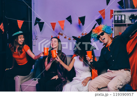 Joyful office Halloween party with coworkers in costumes, celebrating with drinks and laughter, fostering teamwork and festive spirit Joyful office Halloween party with coworkers in costumes, celebrating with drinks and laughter, fostering teamwork and festive spirit 119390957