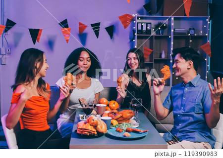 Joyful office Halloween party with coworkers in costumes, celebrating with drinks and laughter, fostering teamwork and festive spirit 119390983