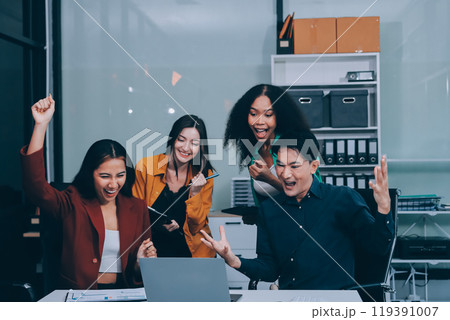 Young corporate employees sitting in office looking at laptop screen reading good news excited happy team diverse people celebrating victory win command success excellent result professional teamwork Young corporate employees sitting in office looking at laptop screen reading good news excited happy team diverse people celebrating victory win command success excellent result professional teamwork 119391007