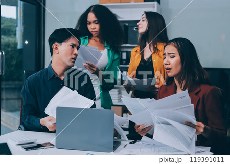 Stress, business people and employee frustrated with multitasking, pressure or overworked by team in chaos with paperwork. Anxiety, headache and worker overwhelmed by group and burnout in crisis 119391011
