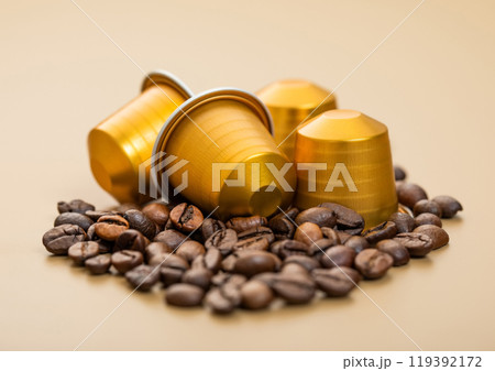 Fresh aroma natural organic coffee aluminium capsules pods on beige background. Fresh aroma natural organic coffee aluminium capsules pods on beige background. 119392172