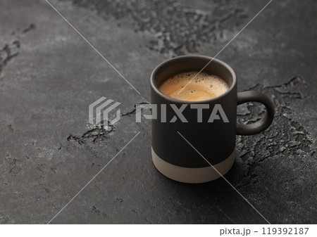Cup of fresh hot morning black coffee with cream on black background. Cup of fresh hot morning black coffee with cream on black background. 119392187