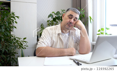 Man Napping at Desk 119392265