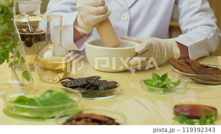 Creative photo template for shampoo advertising, which extracted from natural ingredient, from close up front view. Scientist using mortar and pestle for shampoo study Creative photo template for shampoo advertising, which extracted from natural ingredient, from close up front view. Scientist using mortar and pestle for shampoo study 119392343