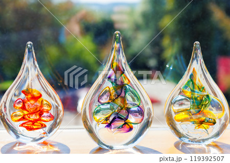 Colorful glass art sculptures displayed in sunlight Colorful glass art sculptures displayed in sunlight 119392507