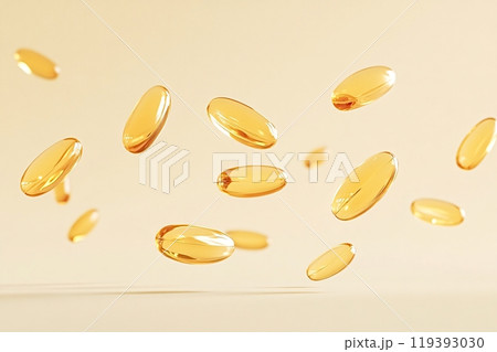 Golden vitamin pills floating on a light yellow background 119393030