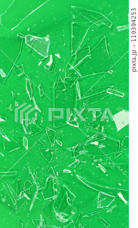 Close-up of shattering glass on green screen background , freeze motion 119394253