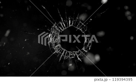 Close-up of gunshot through the glass, shattering against the black background 119394395