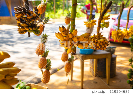 Road side fruit stall selling banana and other fruits Road side fruit stall selling banana and other fruits 119394685