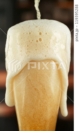 Pouring Beer into Long Glass, Vertical Composition. Pouring Beer into Long Glass, Vertical Composition. 119395288