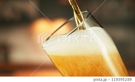 Pouring Beer into Long Glass. Closeup. Pouring Beer into Long Glass. Closeup. 119395289