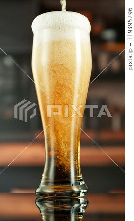 Pouring Beer into Long Glass, Vertical Composition. 119395296