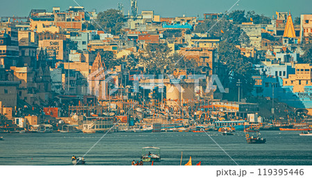 Varanasi, Uttar Pradesh, India. Boats Floating Near Rana Mahal Ghat, Darbhanga Ghat And Dashashwamedh Ghat In Early Morning. Many Hindu Temples. View From Riverbank Embankment Varanasi, Uttar Pradesh, India. Boats Floating Near Rana Mahal Ghat, Darbhanga Ghat And Dashashwamedh Ghat In Early Morning. Many Hindu Temples. View From Riverbank Embankment 119395446