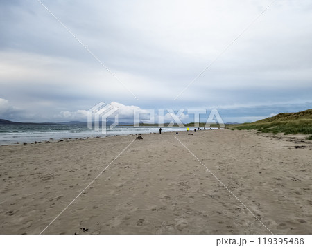 20 man are competing in a fishing competition on the beach. 119395488