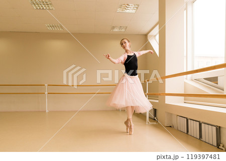 Ballet dancer performing graceful turn en pointe Ballet dancer performing graceful turn en pointe 119397481