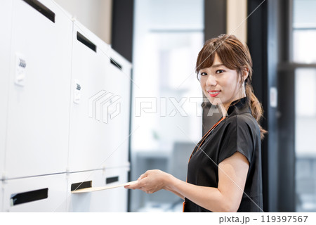 定形外郵便封筒を郵便受けに入れるビジネスパーソン 定形外郵便封筒を郵便受けに入れるビジネスパーソン 119397567