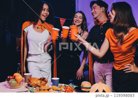 Joyful office Halloween party with coworkers in costumes, celebrating with drinks and laughter, fostering teamwork and festive spirit 119398083