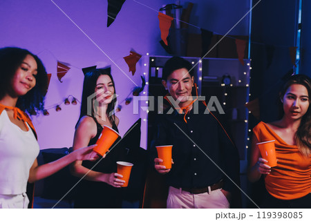 Joyful office Halloween party with coworkers in costumes, celebrating with drinks and laughter, fostering teamwork and festive spirit 119398085