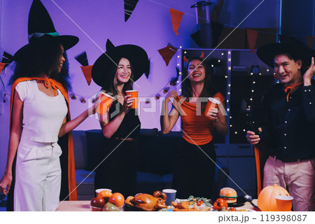 Joyful office Halloween party with coworkers in costumes, celebrating with drinks and laughter, fostering teamwork and festive spirit Joyful office Halloween party with coworkers in costumes, celebrating with drinks and laughter, fostering teamwork and festive spirit 119398087