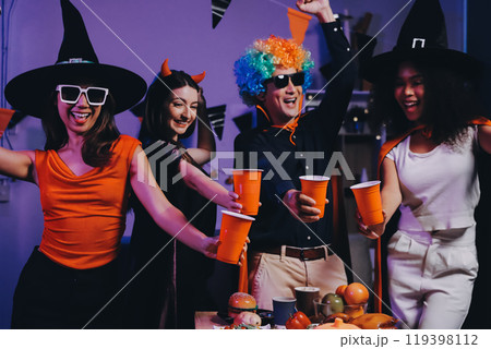 Joyful office Halloween party with coworkers in costumes, celebrating with drinks and laughter, fostering teamwork and festive spirit Joyful office Halloween party with coworkers in costumes, celebrating with drinks and laughter, fostering teamwork and festive spirit 119398112