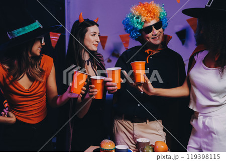 Joyful office Halloween party with coworkers in costumes, celebrating with drinks and laughter, fostering teamwork and festive spirit Joyful office Halloween party with coworkers in costumes, celebrating with drinks and laughter, fostering teamwork and festive spirit 119398115