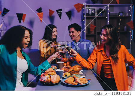 Joyful office Halloween party with coworkers in costumes, celebrating with drinks and laughter, fostering teamwork and festive spirit 119398125