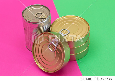 A Group of Stacked Tin Cans on Split Green and Cyan Background 119398655
