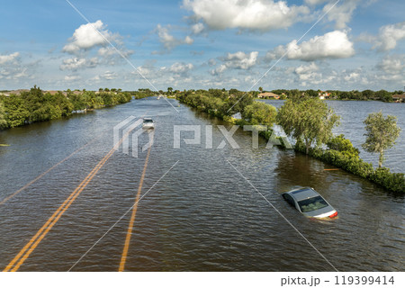 Hurricane flooded car on city street in surrounded with water Florida residential area. Consequences of hurricane Debby natural disaster Hurricane flooded car on city street in surrounded with water Florida residential area. Consequences of hurricane Debby natural disaster 119399414