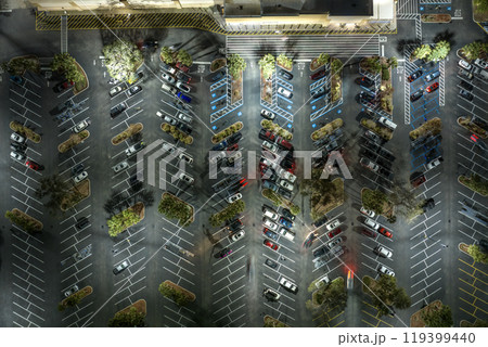 Many parked cars on store parking lot with lines and markings for parking places and directions. Place for vehicles in front of a shopping mall center 119399440