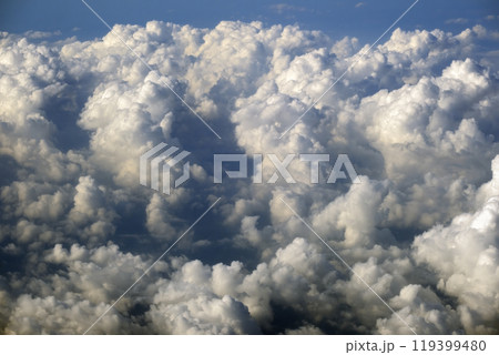 Rain clouds forming at high altitude. View from plane window at high altitude of sky. Air travel concept 119399480