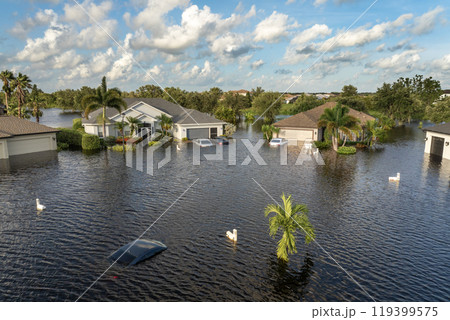 Flooded Florida street with stuck car after hurricane Debby rainfall surrounded with water. Consequences of natural disaster Flooded Florida street with stuck car after hurricane Debby rainfall surrounded with water. Consequences of natural disaster 119399575
