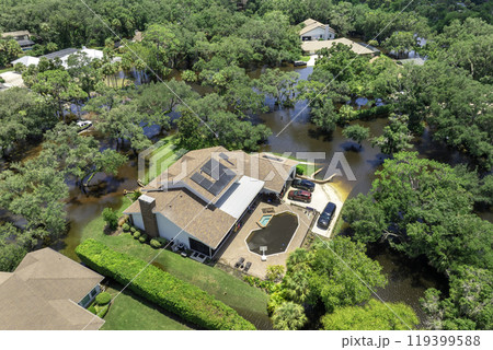 Flooding in Florida caused by tropical storm from hurricane rainfall. Suburb houses in residential community surrounded by flood waters. Aftermath of natural disaster Flooding in Florida caused by tropical storm from hurricane rainfall. Suburb houses in residential community surrounded by flood waters. Aftermath of natural disaster 119399588