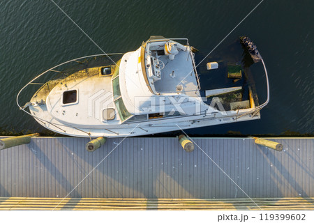 Half sunken sailing yacht capsized on shallow bay waters after hurricane Ian in Manasota, Florida 119399602