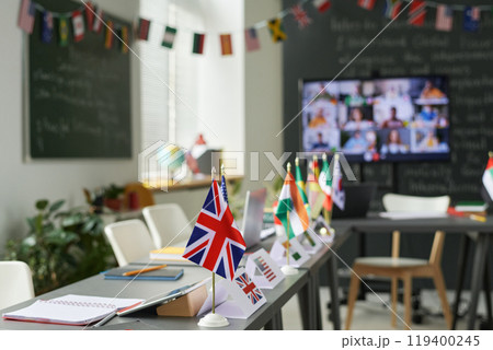 Background image of school classroom set up for international conference with country flags on tables, copy space Background image of school classroom set up for international conference with country flags on tables, copy space 119400245
