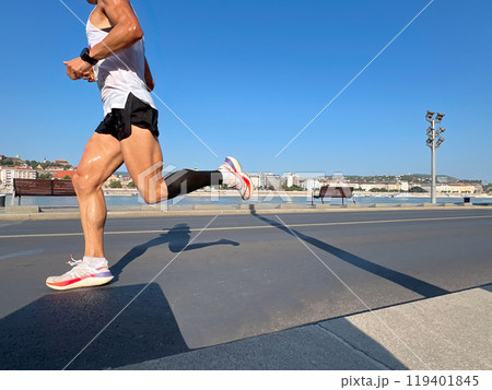male runner running marathon, sweaty muscular athlete legs 119401845