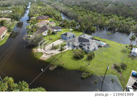 Consequences of natural disaster. Heavy flood with high water surrounding residential houses after hurricane Ian rainfall in Florida residential area Consequences of natural disaster. Heavy flood with high water surrounding residential houses after hurricane Ian rainfall in Florida residential area 119401999