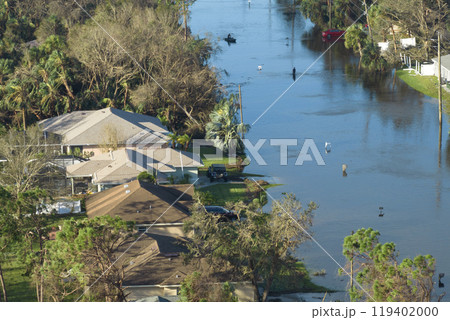 Consequences of natural disaster. Heavy flood with high water surrounding residential houses after hurricane rainfall in Florida residential area Consequences of natural disaster. Heavy flood with high water surrounding residential houses after hurricane rainfall in Florida residential area 119402000