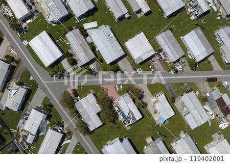 Consequences of natural disaster. Severely damaged houses after hurricane Ian in Florida mobile home residential area Consequences of natural disaster. Severely damaged houses after hurricane Ian in Florida mobile home residential area 119402001