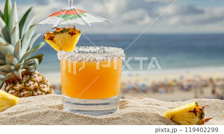 Tropical Beachside Pineapple Cocktail with Umbrella and Salt Rim on Sandy Shore 119402299