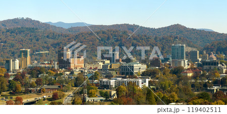 Aerial view of Asheville city in North Carolina with high buildings and mountain hills in distance 119402511