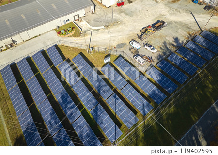 Aerial view of large sustainable electrical power plant with rows of solar photovoltaic panels for producing clean electric energy. Concept of renewable electricity with zero emission Aerial view of large sustainable electrical power plant with rows of solar photovoltaic panels for producing clean electric energy. Concept of renewable electricity with zero emission 119402595