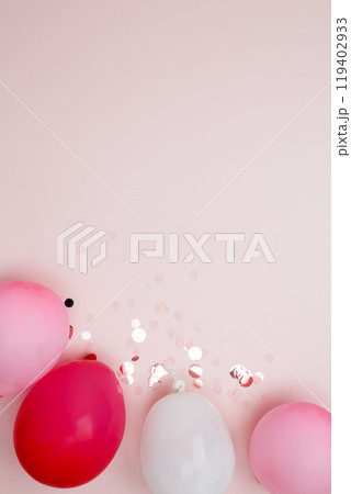 Birthday attributes colorful balloons and confetti. Concept of festive birthday celebrations 119402933