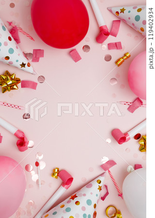 Birthday attributes colorful balloons, party hats, candles, and confetti. Concept of festive birthday celebrations 119402934