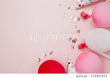 Birthday attributes colorful balloons, party hats and confetti. Concept of festive birthday celebrations 119402935