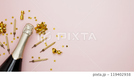 Blank card surrounded by confetti and bottle of champagne. Concept of festive birthday celebrations Blank card surrounded by confetti and bottle of champagne. Concept of festive birthday celebrations 119402938