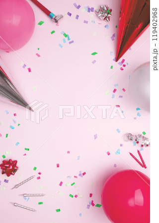 Birthday attributes colorful balloons, party hats, candles, and confetti. Concept of festive birthday celebrations 119402968