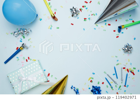 Birthday attributes colorful balloons, party hats, candles, and confetti. Concept of festive birthday celebrations Birthday attributes colorful balloons, party hats, candles, and confetti. Concept of festive birthday celebrations 119402971